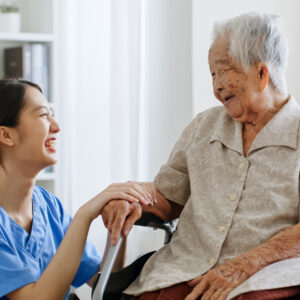 Young Asian woman, nurse, caregiver, carer of nursing home talking with senior Asian woman feeling happy at home